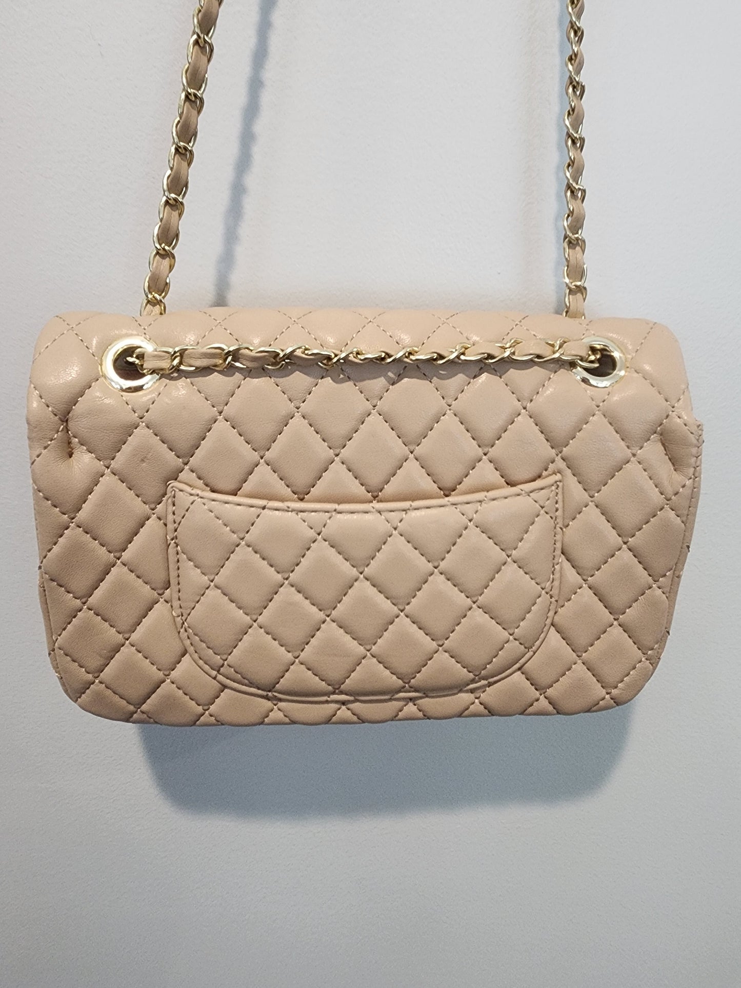 Quilted Leather beige purse with gold tone accents and chain.