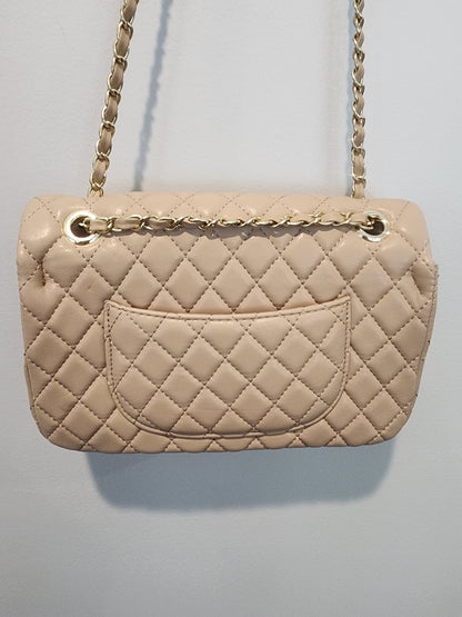 Quilted Leather beige purse with gold tone accents and chain.